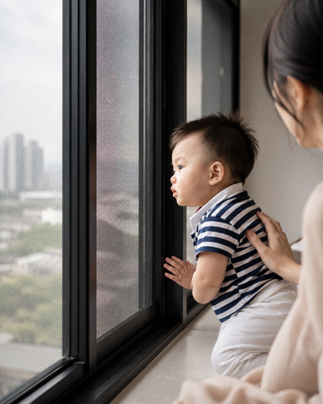 A child breathing easy beside a window fitted with the AIS anti-smog screen